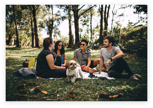 Image of four people and a dog having a picnic outdoors. You can find joy again after working with a burnout therapist in Los Angeles, CA. 91108 | 90232