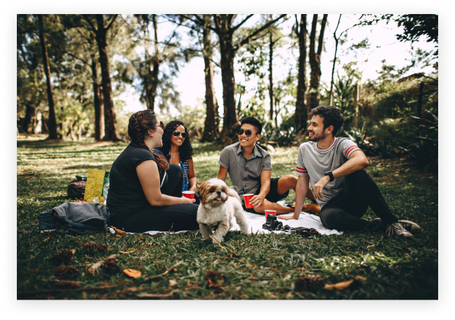 Image of four people and a dog having a picnic outdoors. You can find joy again after working with a burnout therapist in Los Angeles, CA. 91108 | 90232