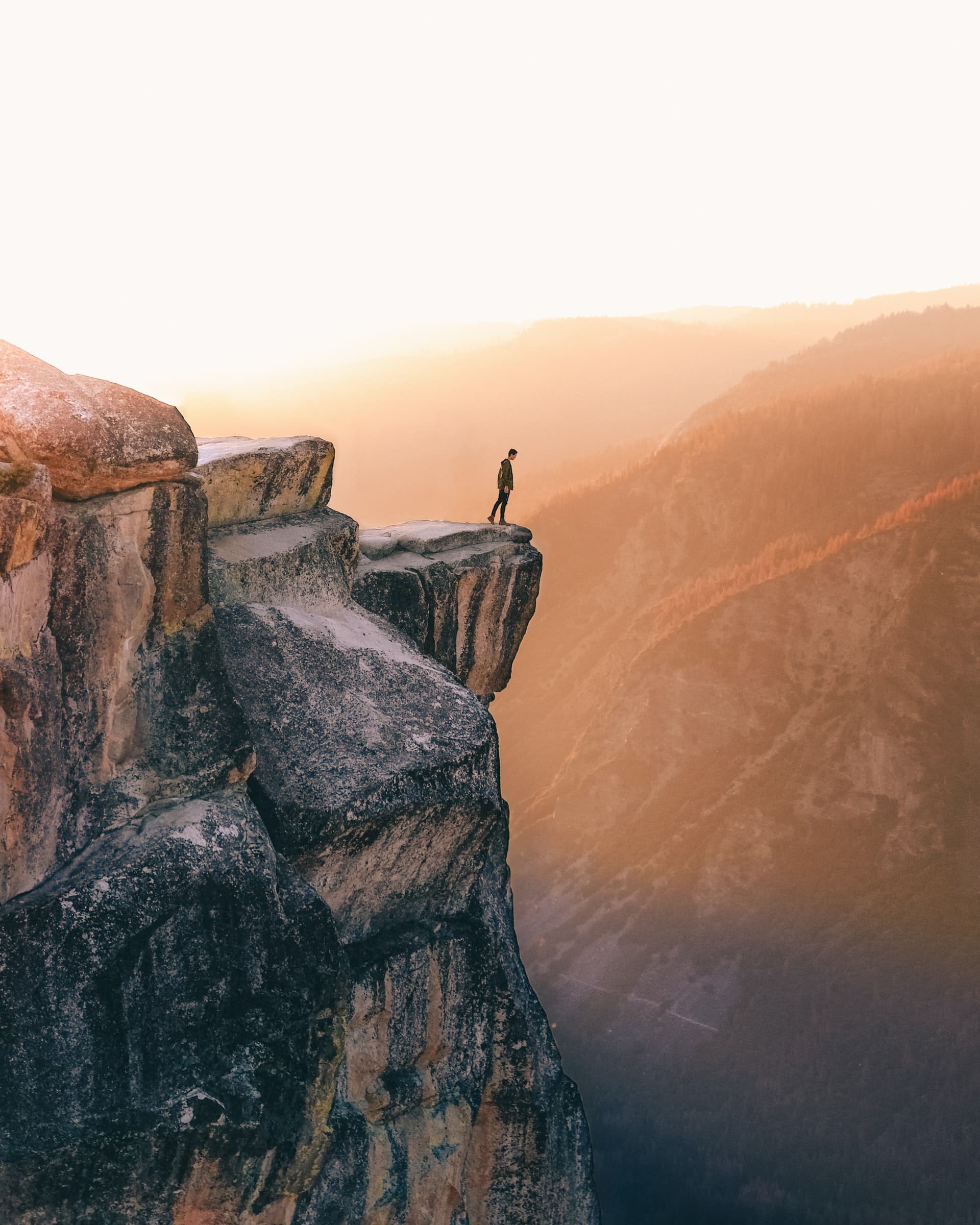 Image of a man standing at the edge of a cliff. This photo represents how one might feel while experiencing symptoms of PTSD. Completing trauma therapy and PTSD treatment in Los Angeles, CA can help reduce symptoms of PTSD. | 90071 | 90232