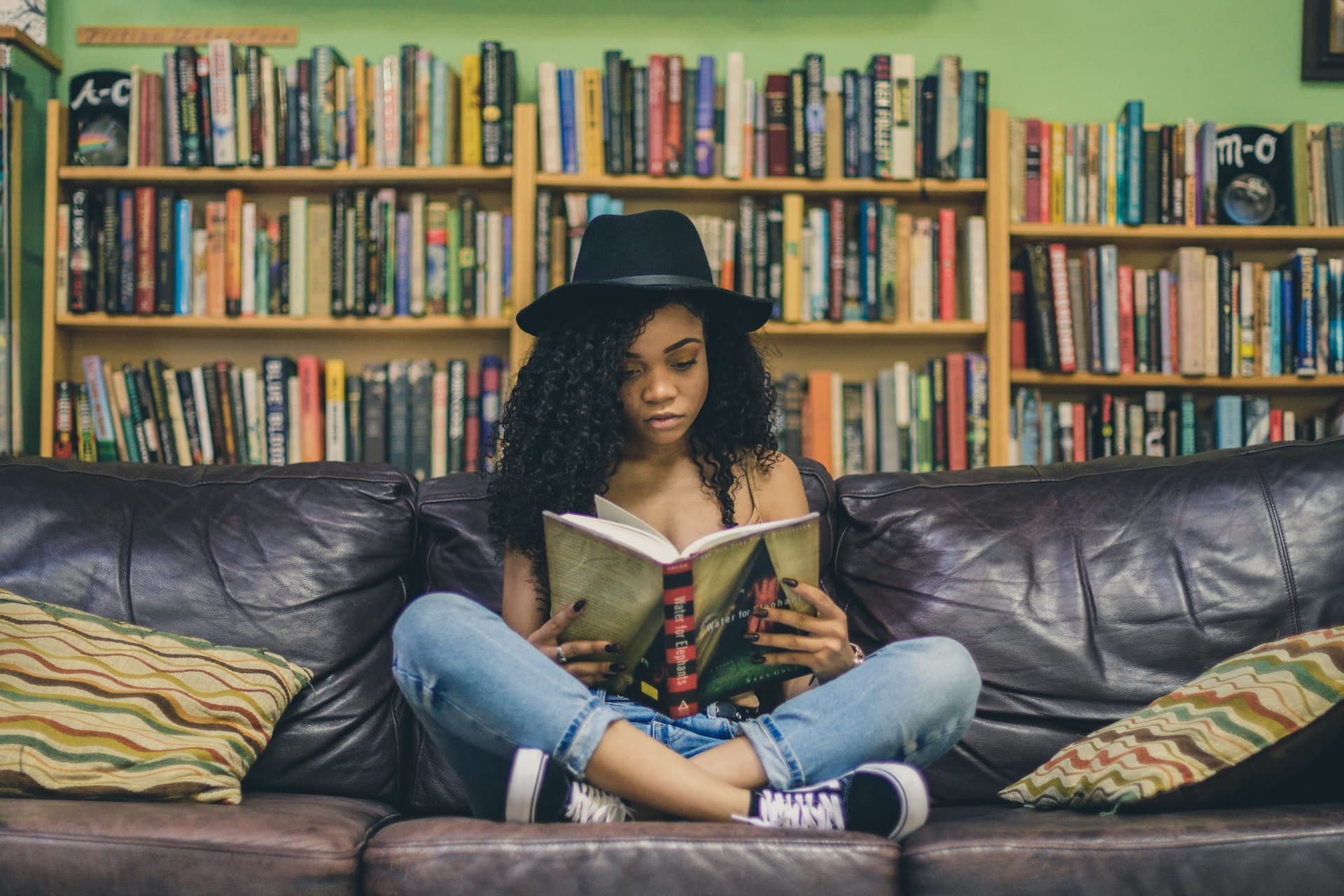 Image of a teenage girl sitting on a couch and reading a book. This girl represents what someone searching "therapy for teens in Los Angeles, CA" may look like. If your teen needs support, working with a teen therapist in Los Angeles, CA can help. | 90404 | 90503 |