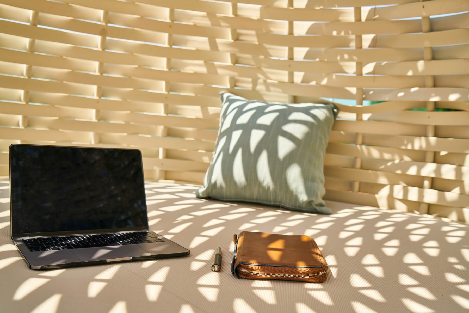 Image of a laptop, notebook, and pillow sitting in the sun on a lounge bed. This image is representative of the environment you can do online therapy in California from. Working with an online therapist in Los Angeles, CA allows you receive online anxiety treatment from your home. | 91006 | 90071
