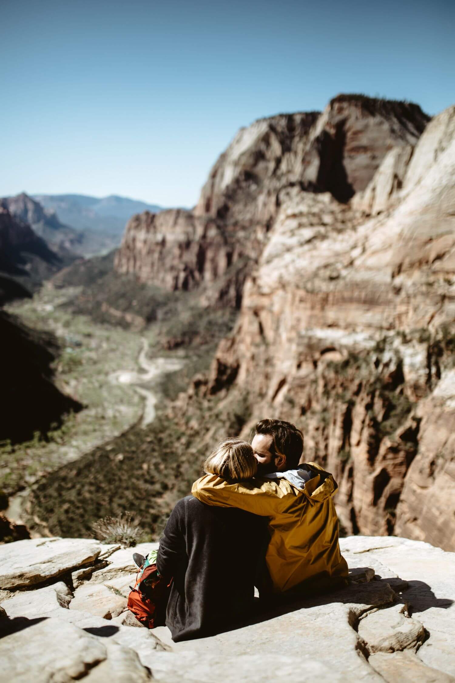 Image of a couple sitting on top of a mountain after hiking together. Couples can find shared hobbies during marriage counseling in Los Angeles, CA. A couples therapist in Los Angeles, CA can help partners reconnect and rekindle love. | 91006 | 90071