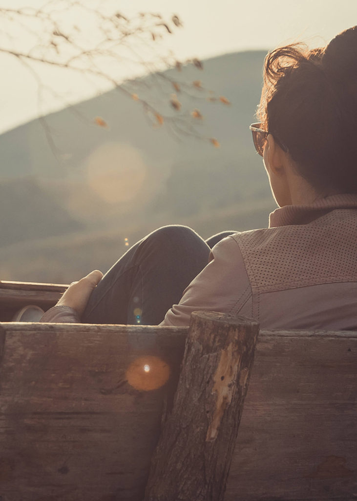 Image of a person sitting on a bench and thinking. This image depicts what someone may look like while considering adult ADHD treatment in Los Angeles, CA. Starting with an ADHD therapist can help decrease symptoms. (91006, 90071).
