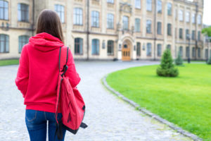 Image of teenager with a backpack walking toward school. This image depicts someone needing therapy for teens in Los Angeles, CA. They can get support from a teen therapist in Los Angeles, CA through online therapy. 90404 | 90503