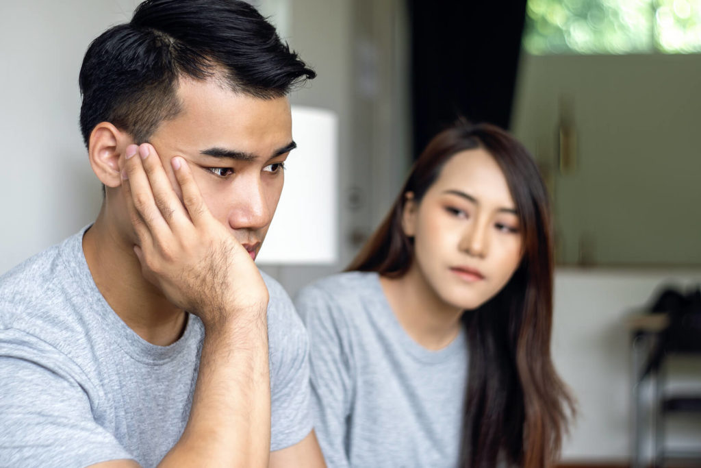 Asian couple looking at each other upset. Adult ADHD therapy and coaching in Los Angeles with an Asian Therapist can help you find peace.