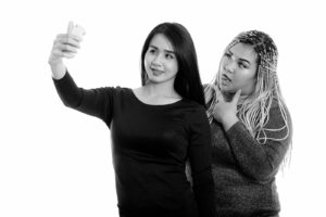 Women taking a selfie together. Representing sexualizing asian women. Get body image support from an Asian therapist at Yellow Chair Collective who offers therapy in Los Angeles, CA and online therapy in California (90404, 90503, 91006.) If you’re struggling with anxiety related to your body image, our therapy for asian women in Los Angeles, CA can help. Our culturally sensitive therapy is perfect for you.