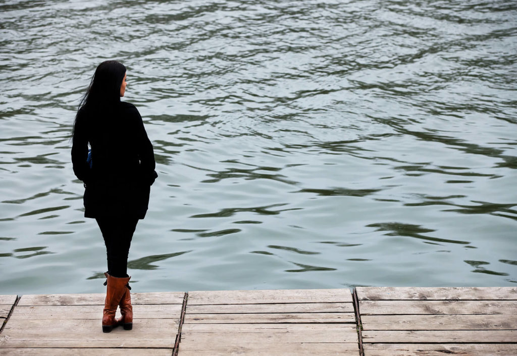 Woman standing on dock looking somber. The asian American experience is hard, let our specialized asian American therapist in Los Angeles help. (90404, 90503, 91006.) We provide therapy for asian women at our culturally sensitive therapy practice in Los Angeles, CA. 