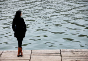Woman on dock representing the conflicts that can occur between an Asian woman and mother.