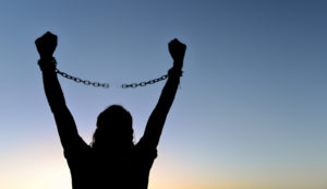 Image of a person with their arms above their head breaking a chain. This image depicts the freedom found in PTSD treatment in Los Angeles, CA. The trauma therapists at our practice understand the Asian American experience. | 91006 | 90071