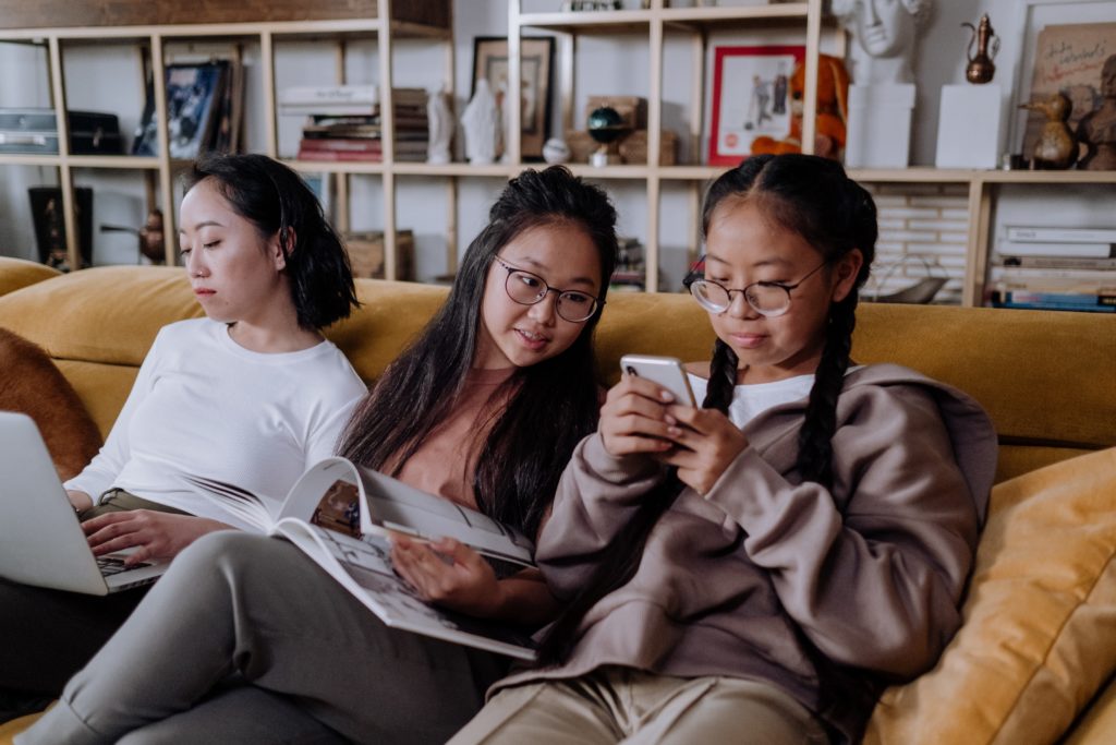 Image of asian family on couch together. This image could depict a family in search of a culturally sensitive therapist in Los Angeles, ca. 91108 | 90232