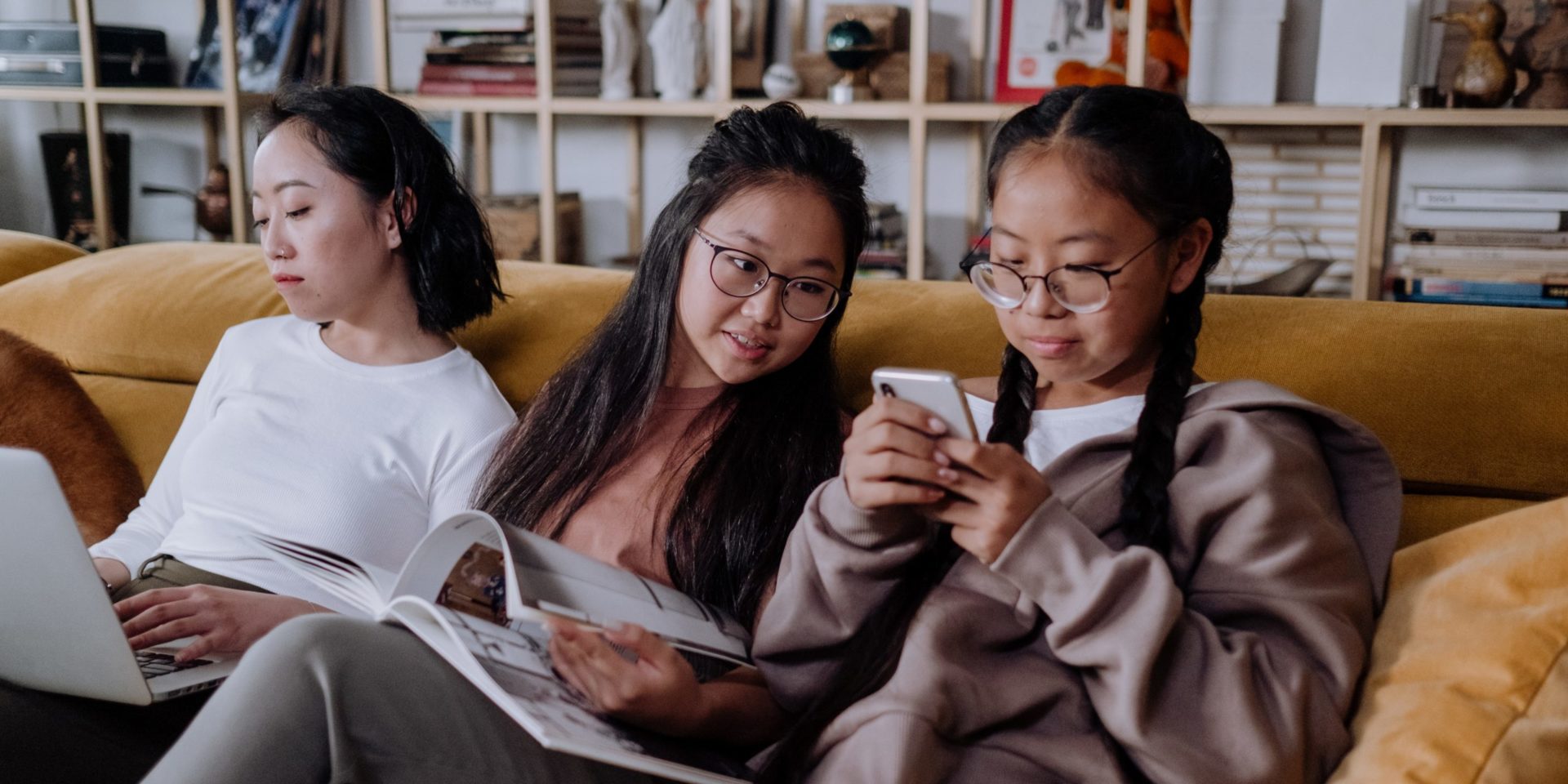 Image of asian family on couch together. This image could depict a family in search of a culturally sensitive therapist in Los Angeles, ca. 91108 | 90232