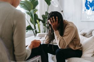 Image of a person stressed on a couch. This person could be seeking EMDR therapy in Los Angeles, ca. EMDR can help you in trauma therapy and PTSD treatment. | 90404 | 90505