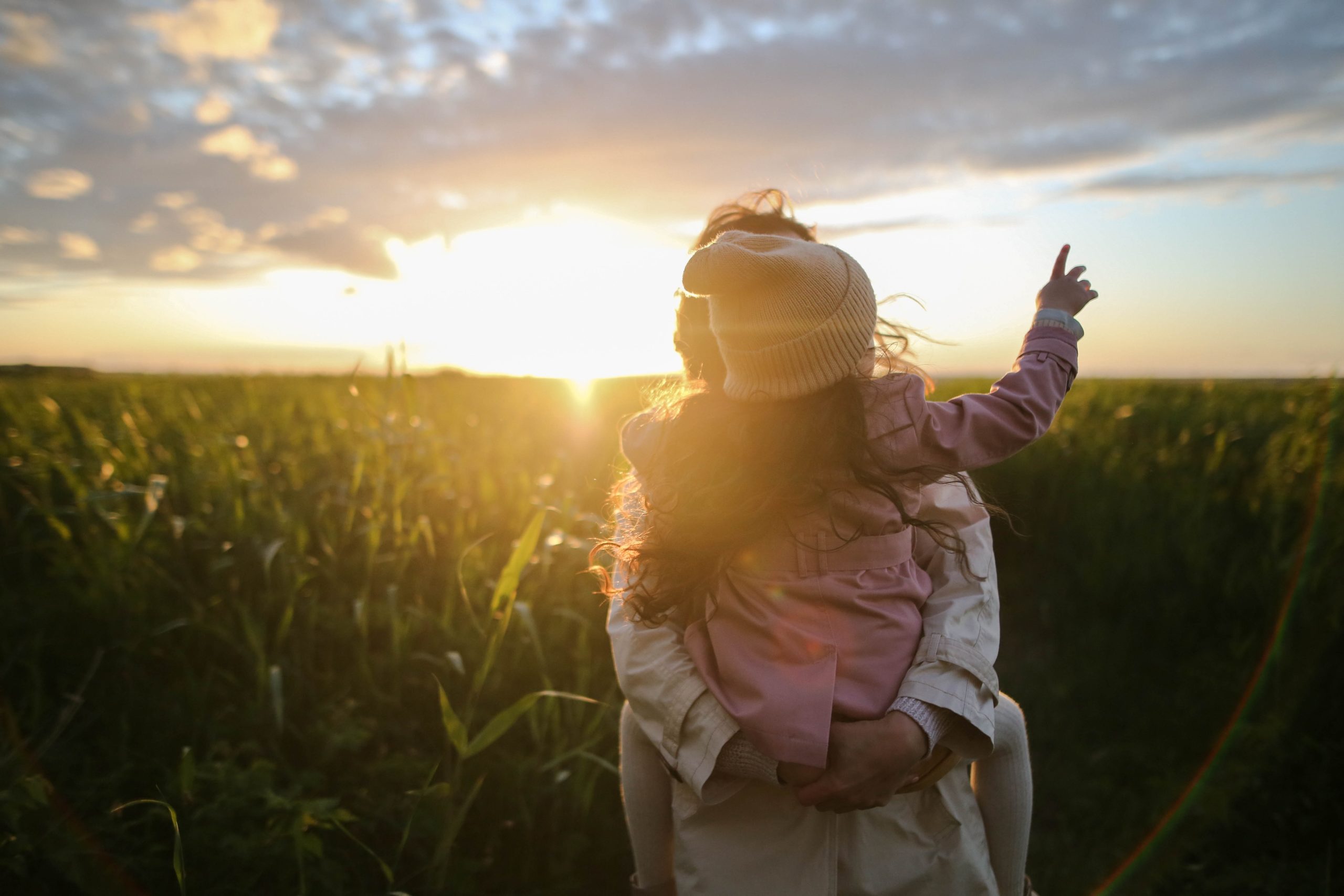 Person holding their kid in a corn field in the sunset. Everyone can feel by being supported by a Los Angeles based group therapy practice that specializes in Asian American mental health. An Asian American therapist in Los Angeles or New York can help with Asian American Therapy near you.