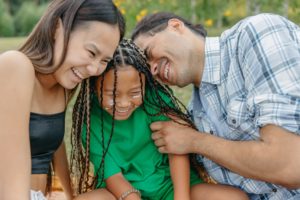 A happy family laughing together representing that setting boundaries can bring harmony to families in the Los Angeles, California area.