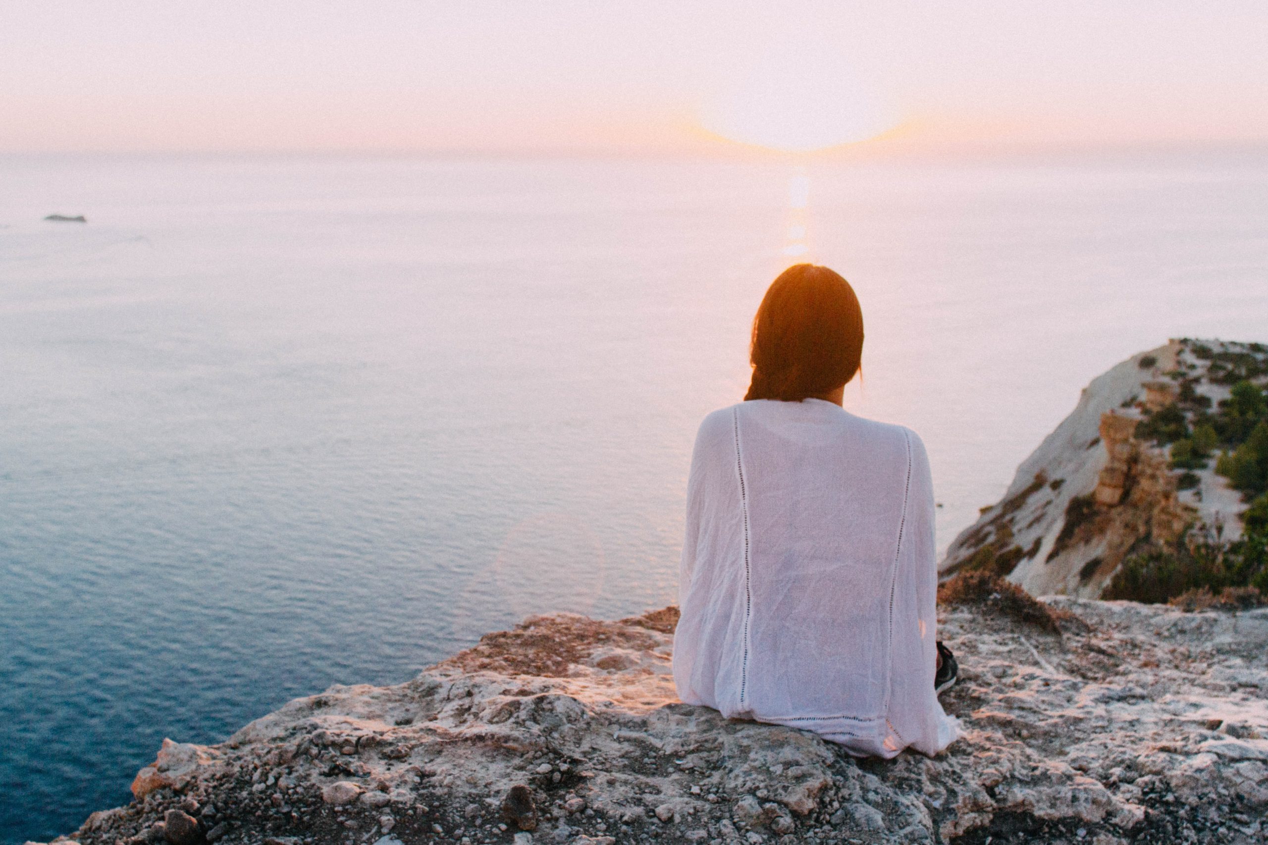 A woman sitting and looking at the sea representing the hope and rest one can feel by being supported by a Los Angeles based group therapy practice that specializes in Asian American mental health. An Asian American therapist in Los Angeles or New York can help with Asian American Therapy near you.