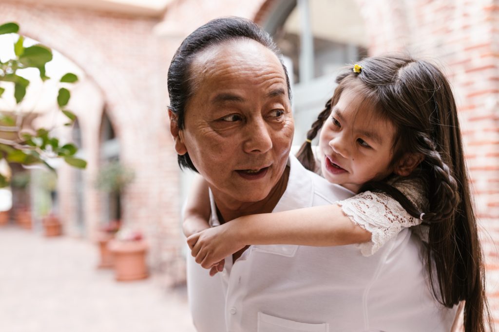 Grandfather and granddaughter representing our there can be appropriate boundaries within Asian American households to form closer bonds and have healthier mental health in the Los Angeles, California area.