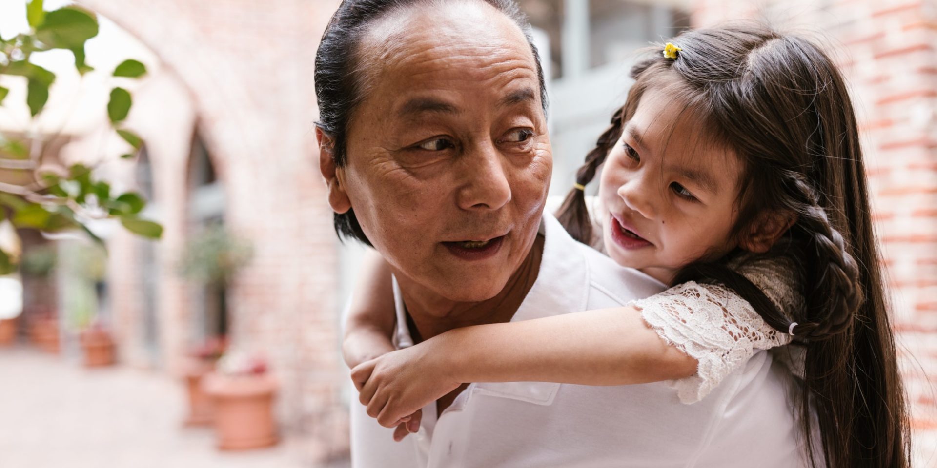 Grandfather and granddaughter representing our there can be appropriate boundaries within Asian American households to form closer bonds and have healthier mental health in the Los Angeles, California area.