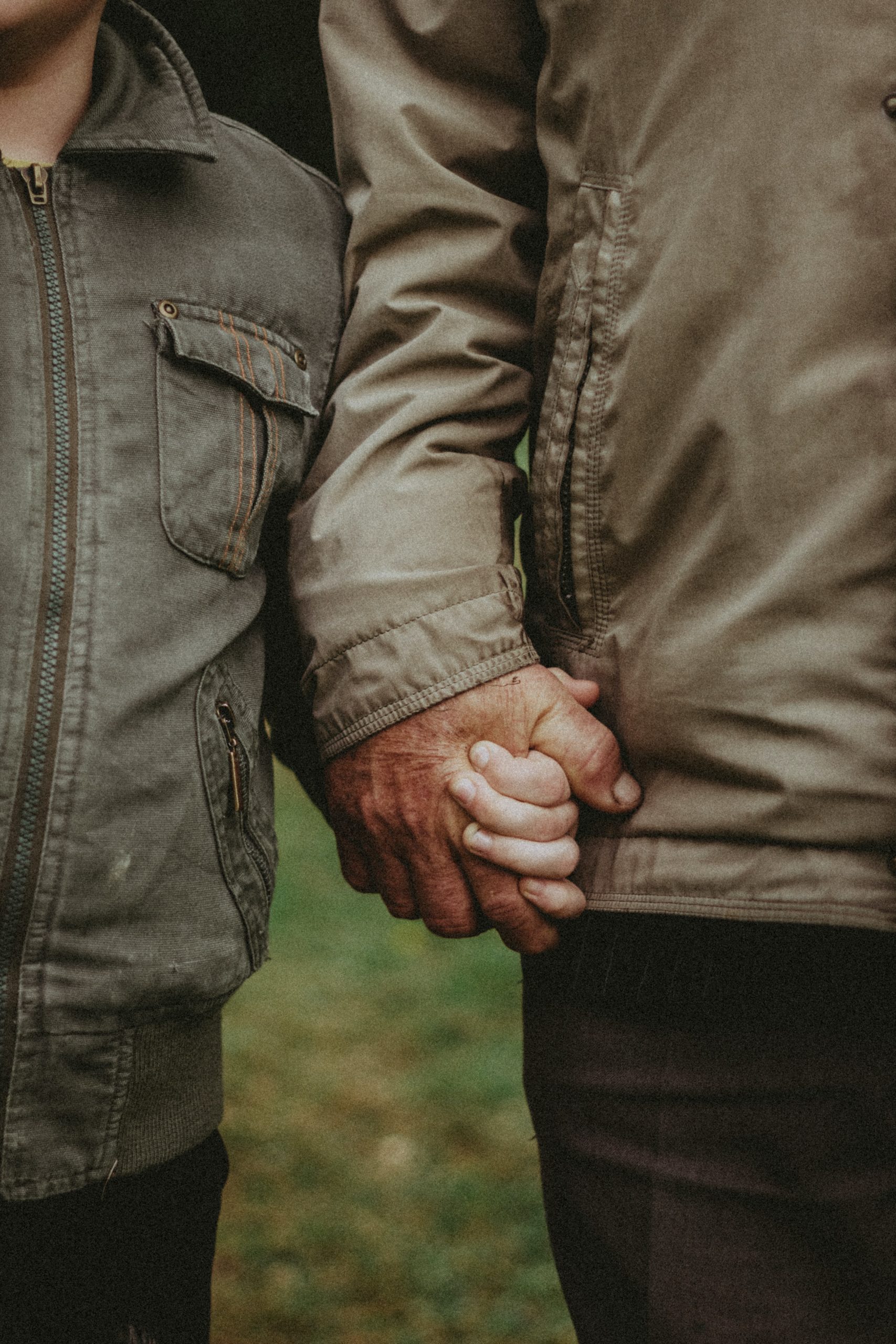 Father and son holding hands close-up. Everyone can feel by being supported by a Los Angeles based group therapy practice that specializes in Asian American mental health. An Asian American therapist in Los Angeles or New York can help with Asian American Therapy near you.