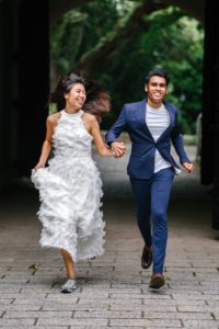 A multicultural couple running and enjoying their day representing the freedom they feel after deeply connecting with one another, recognizing their difference, but also growing together.
