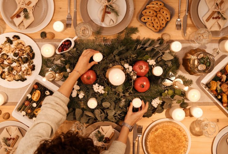 A top-down view of a dinner table with holiday decor and dishes. This could symbolize the bonds cultivated after navigating holiday stress. Learn more about the support a stress management therapist in Los Angeles, CA can offer by searching for an Asian therapist in New York or LA with Yellow Chair Collective.