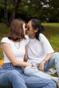 Two women sharing a kiss representing how relationships can still function when one identifies as an ADHDer in Los Angeles, CA. Learn how online couples therapy in California can support you in navigating adult ADHD in Los Angeles, CA today. Couples therapy and marriage counseling in Los Angles, CA can help your relationship.
