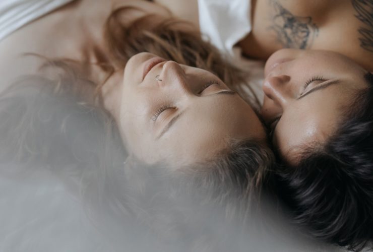 Two women in bed with their heads against one another representing how ADHD affects relationships in Los Angeles, California