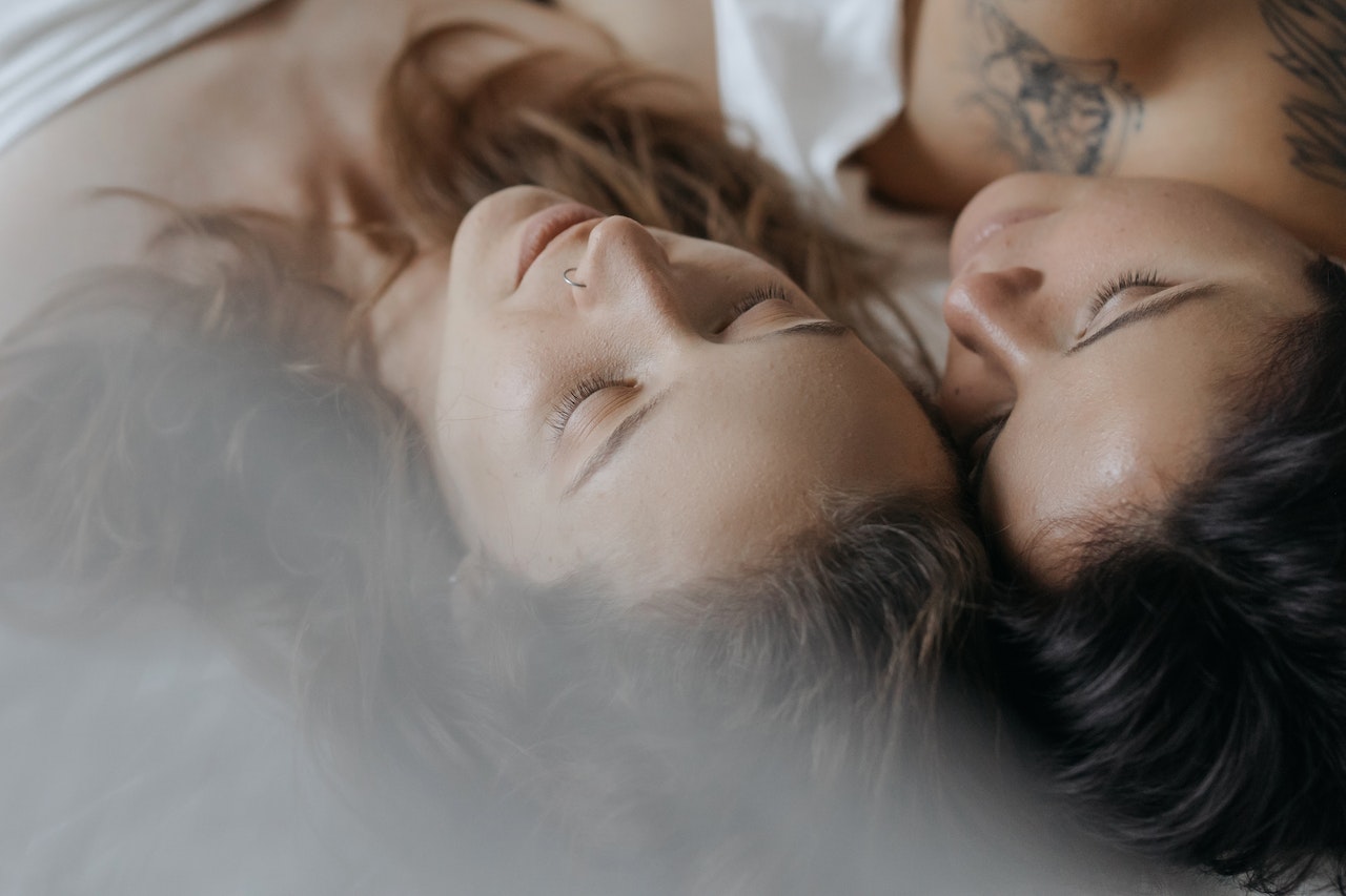Two women in bed with their heads against one another representing how ADHD affects relationships in Los Angeles, California