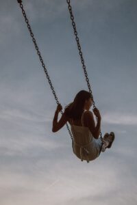 Asian American woman swinging on a swing representing the freedom she feels after receiving adult ADHD therapy and coaching in Los Angeles, CA. Contact an ADHD therapist in Los Angeles, CA to learn more about adult ADHD in Los Angeles, CA today. 
