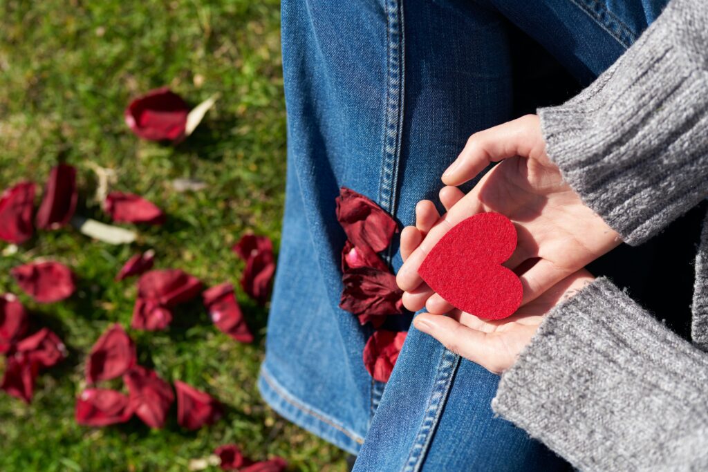 A close up of a person holding a heart. This could represent the bonds cultivated through online therapy for asian americans. Learn more about the support an Asian American therapist in Los Angeles can offer by searching for an Asian American therapist near me today.