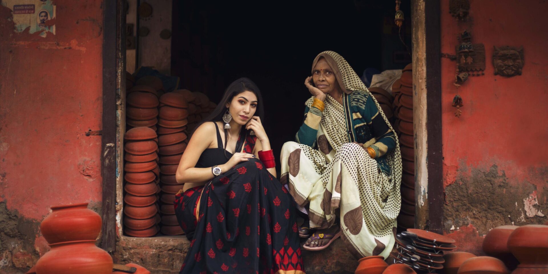 Two women sit on a step in front of a door. Learn how an Asian therapist in New York can offer support for South Asian women. Search for therapy for Asian women in Los Angeles, CA, and NYC today to learn more about therapy for asian women today.