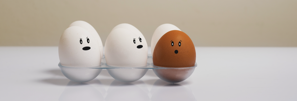 A carton of eggs with different emotion faces to represent the spectrum of emotions that we can feel as humans. The Asian American Emotion Management Coaching group can teach people how to cope with difficult feelings.
