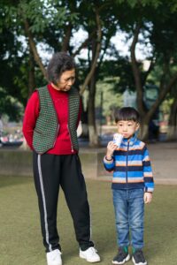 A grandmother stands with a judgemental look toward their grandchild. This could represent the generational differences that an Asian American therapist in Los Angeles can offer. Learn how culturally sensitive therapy in Los Angeles, CA can support you today.
