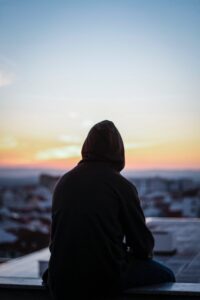 A person sits alone while looking out at a morning sunrise. Learn how a trauma therapist in Los Angeles, CA can offer support with children with ADHD and adult ADHD therapy in Los Angeles, CA. Search for adult adhd therapy and coaching today.
