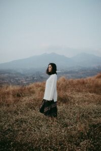 An Asian American woman stands alone in a field. This could represent the isolation of depression that an Asian American therapist in California can address. Learn more about Asian American therapy near me by contacting an asian american therapist in Los Angeles.
