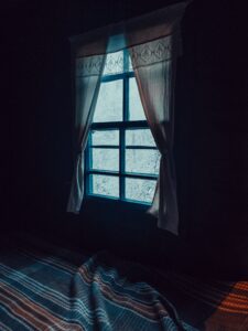 An image of a window in a dark room. This could represent the sleep issues that come from depression that an Asian American therapist can address. Learn more about Asian American therapy near me and other services by searching for an Asian American therapy in New York today.
