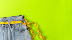 A pair of jeans with a measuring tape serving as a belt. This could represent the struggles of body image that an Asian American therapist in Los Angeles can address. Learn more about an eating disorder support group in Los Angeles, CA and the help it can offer.
