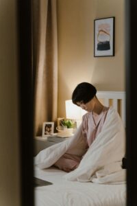 A lone woman sits on a bed. Learn how a trauma therapist in Los Angeles, CA can help you overcome past relationship pain. Search for online trauma therapy in California or search for an Asian american therapist. They can offer support for racial trauma in Los Angeles, CA and more. 
