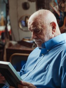 A close up of a man grieving while looking at a photobook. Learn how a trauma therapist in Los Angeles, CA can offer support with relationship heartbreak. Search for trauma therapy in Los Angeles, CA or individual therapy in Los Angeles, CA.
