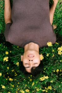 An Asian American individual lays in the grass surrounded by flowers. Learn how an Asian American therapist in California can help cultivate relationships. Search for an Asian therapist in New York or California or search for couples therapy and marriage counseling in Los Angeles, CA.
