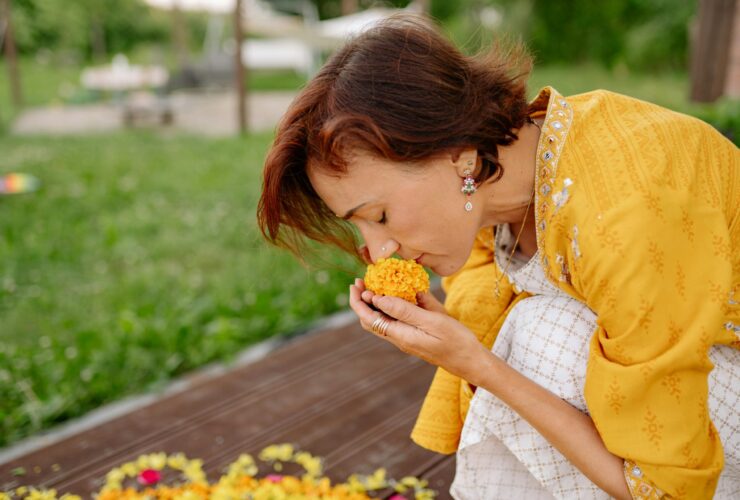 A woman crouched down smelling a yellow flower. Learn how a South Asian support group can help. Search for therapy for South Asian women in Los Angeles, CA, and NYC to learn more about therapy today.