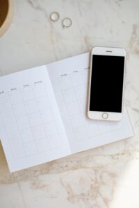 a phone on top of a planner. may represent dating apps