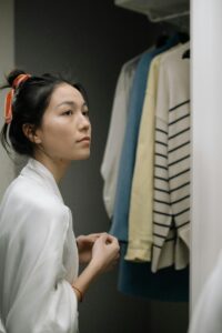 A woman stands in front of an open closet while looking off into the distance. Learn how an online therapist in New York can offer support with addressing neurodiversity and relationships.  Search for a neurodiversity-affirming therapist in Los Angeles, CA to learn how they can offer online therapy in Los Angeles, CA or New York.

