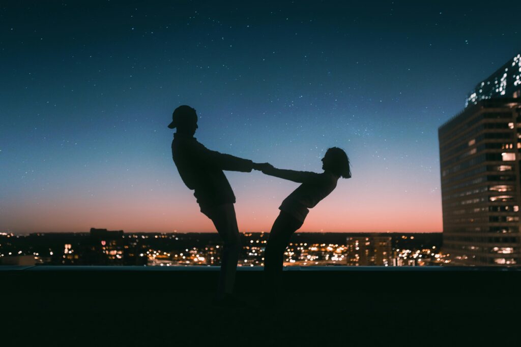 A silhouette of a couple holding hands while overlooking an evening city skyline. Learn how individual therapy in Los Angeles, CA can offer support with dating by searching for online couples therapy in California. An Asian therapist in California can offer support today.
