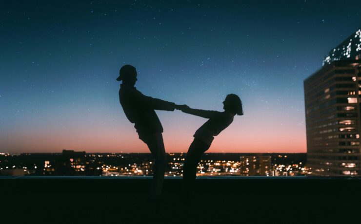 A silhouette of a couple holding hands while overlooking an evening city skyline. Learn how individual therapy in Los Angeles, CA can offer support with dating by searching for online couples therapy in California. An Asian therapist in California can offer support today.