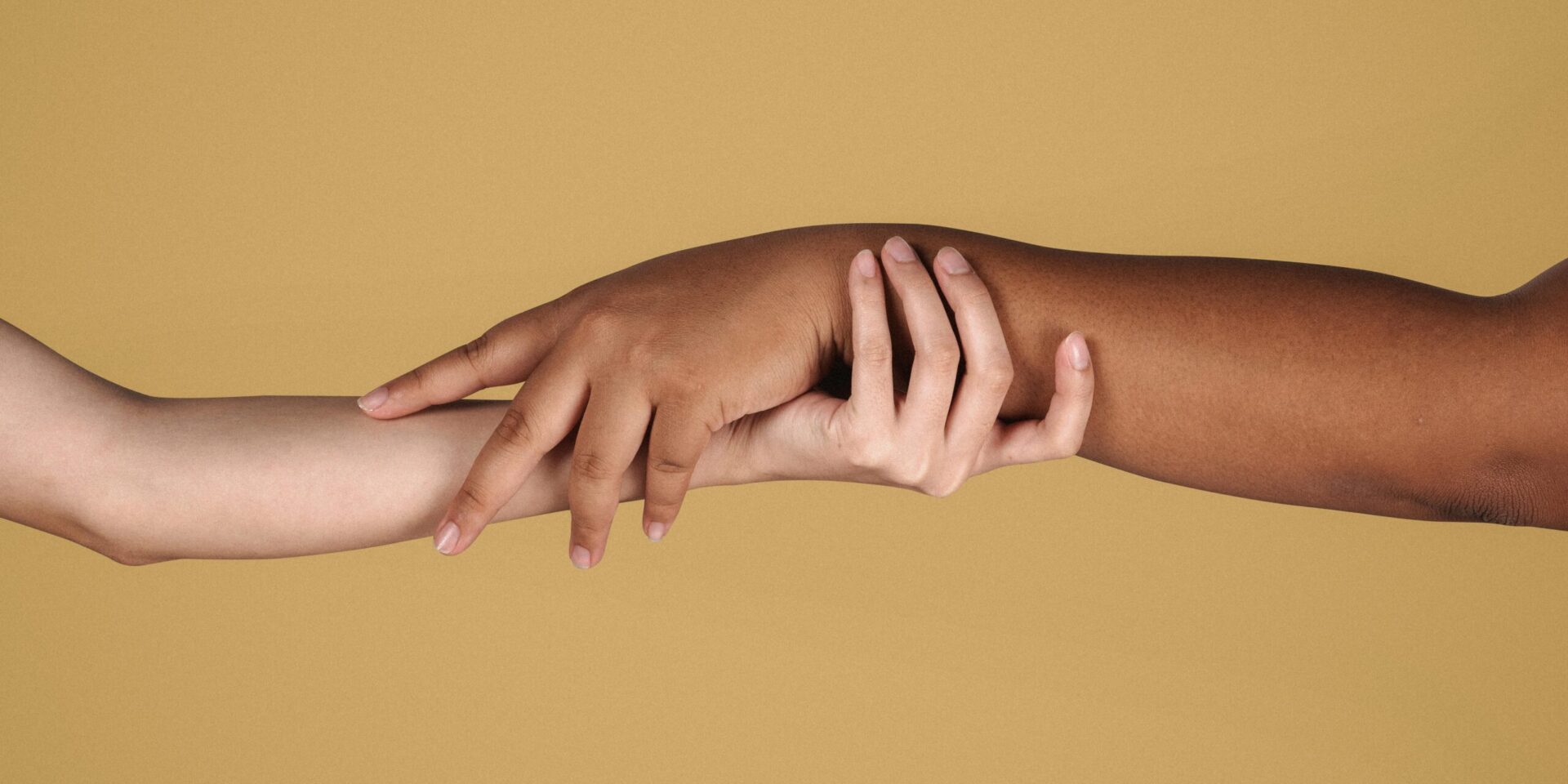 A close up of people holding hands. This could represent the bonds cultivated when working with a neurodiversity-affirming therapist in Los Angeles, CA. Search for an online therapist in New York to learn more about the help an ADHD therapist in Los Angeles, CA or New York can offer.
