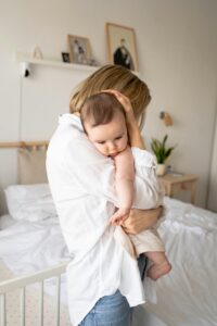 A mother stands while cuddling her baby against her chest. Learn how postpartum therapy in los angeles can offer support with highly sensitive mothers. Search for highly sensitive person treatment in Los Angeles, CA to learn more about the benefits of overcoming postpartum symptoms in Los Angeles, CA. 
