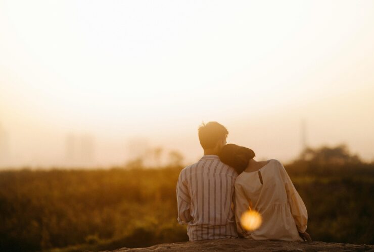 A couple sit together watching the sunset. Learn how a neurodiversity-affirming therapist in Los Angeles, CA. This could represent the bonds cultivated after working with a neurodiversity-affirming therapist in Los Angeles, CA. Search for online couples therapy in California today or individual therapy in Los Angeles, CA.