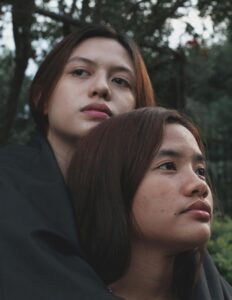 A woman wraps their arms around their partner while standing behind them. This could represent the aftermath of a relationship issue after working with an Asian American therapist in California. Search for couples therapy and marriage counseling in Los Angeles, CA or contact an Asian therapist in New York to learn more.
