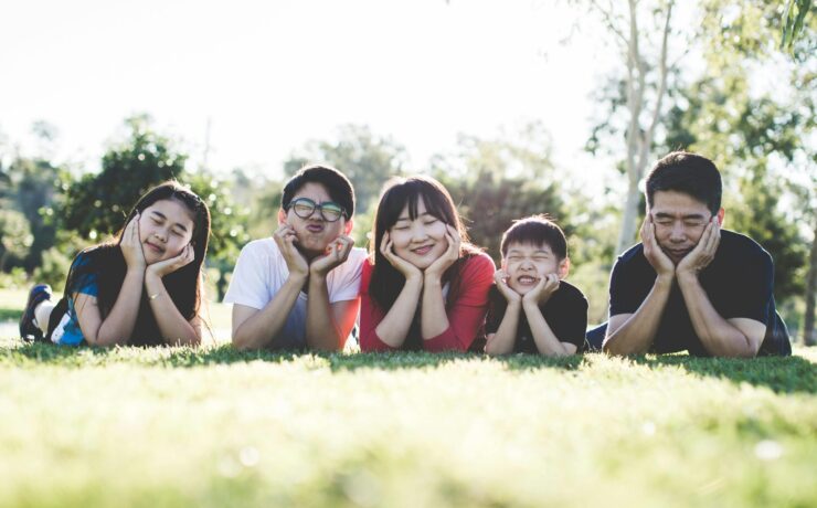 A group of teens lay in the grass while smiling and posing for the camera. This could represent the struggles of ADHD that an ADHD therapist in Los Angeles, CA can help you address. Learn more about therapy for teens in Los Angeles, CA and how ADHD treatment in Los Anglees, CA can help today!