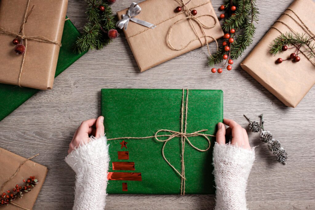 A top down view of a person opening a holiday present. Learn how an Asian American therapist in Los Angeles can offer support during the holiday season. Search for individual therapy in Los Angeles, CA and how online therapy in Los Angeles, CA can offer support today.